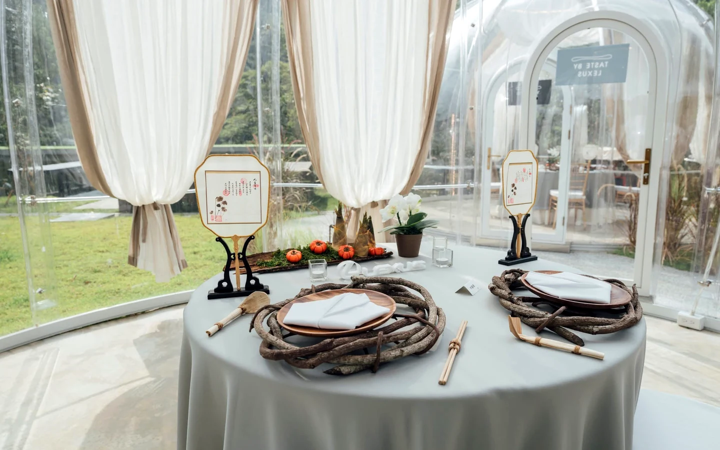Table set for dining inside a Domevora dome with sheer curtains