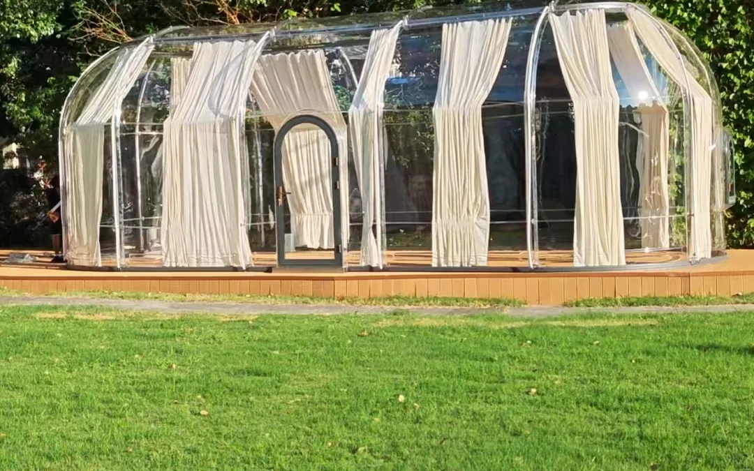 Extended transparent Domevora dome installed on a lawn