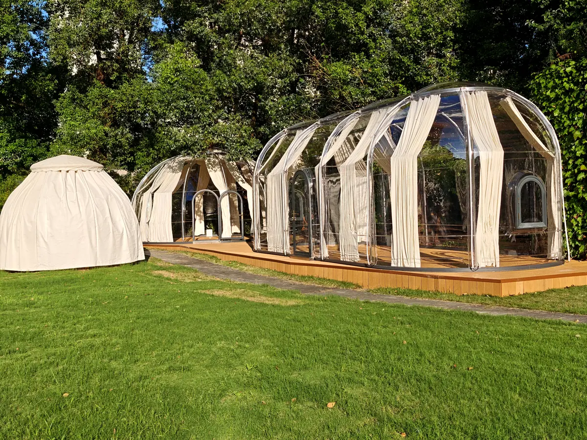 Extended oval Domevora dome on a timber deck and lawn