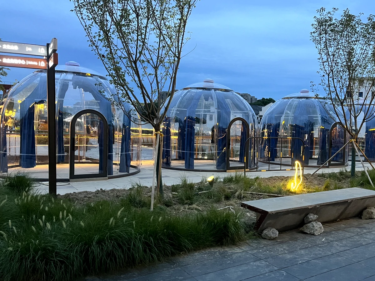 Domevora domes at blue hour beside an outdoor fire feature