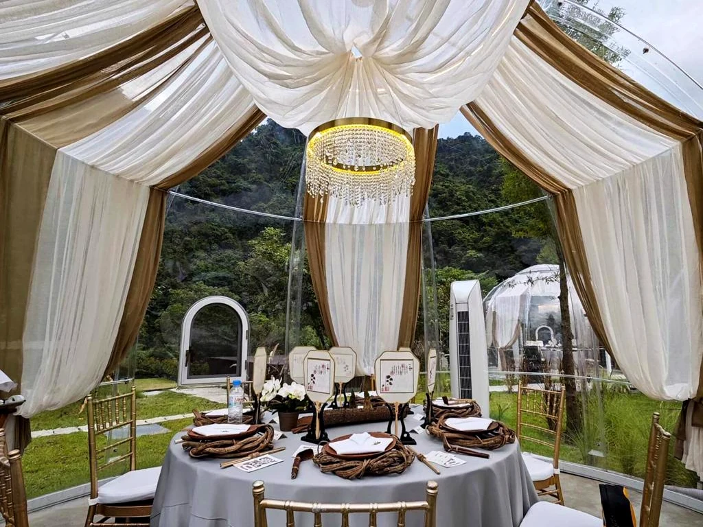 Table set for dining inside a Domevora dome with draped ceiling