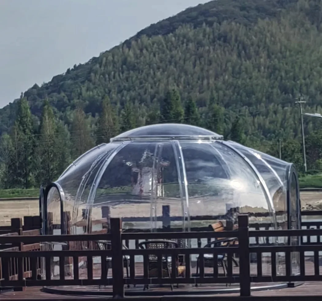 Round 4.0 m Low clear polycarbonate dome: on a raised timber deck beside a lake