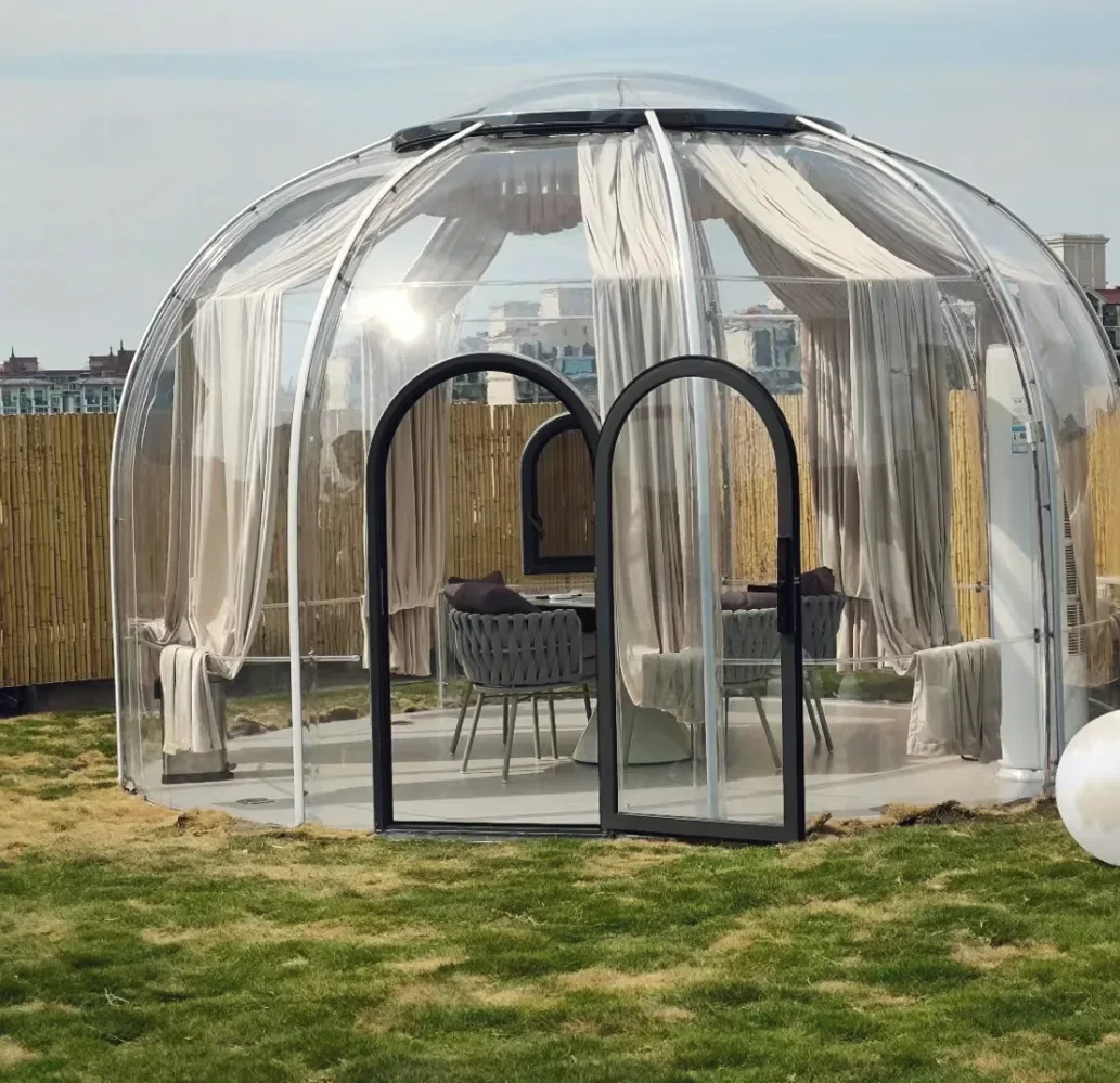Round 4.5 m clear polycarbonate dome: a rooftop lawn, furnished as a lounge with sheer curtains